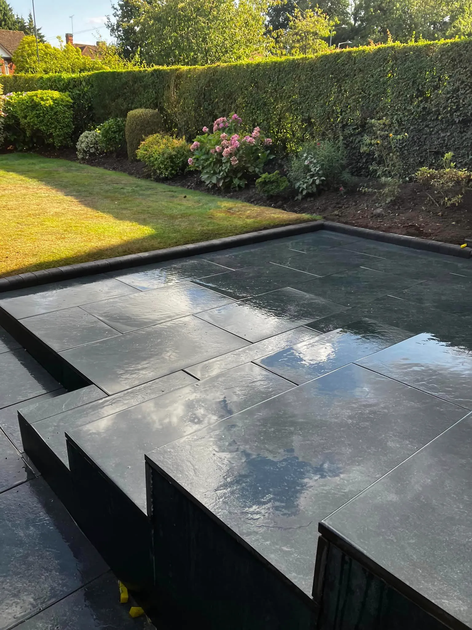 A pool being built in the middle of a garden.